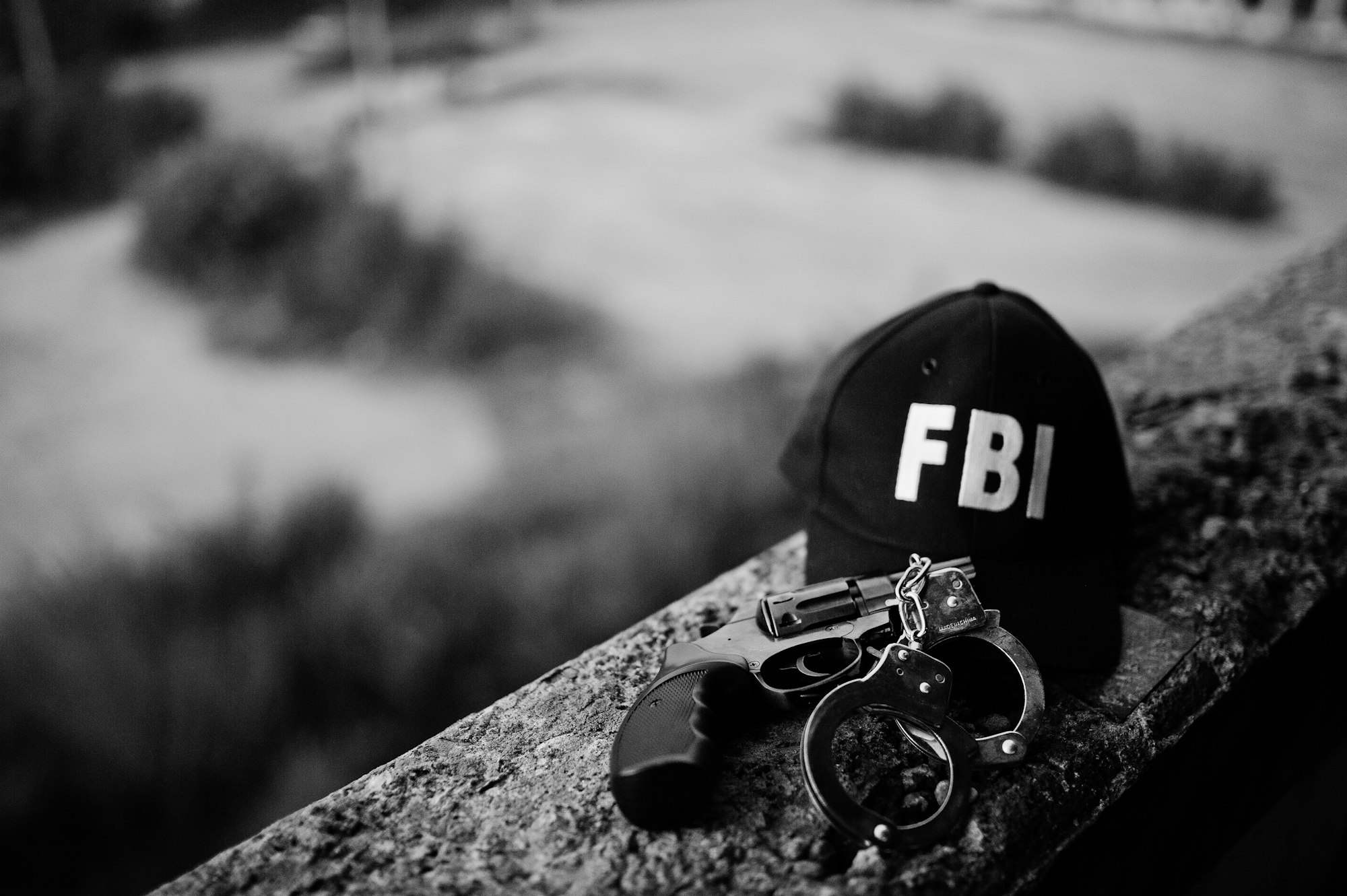 FBI cap with revolver and handcuff.