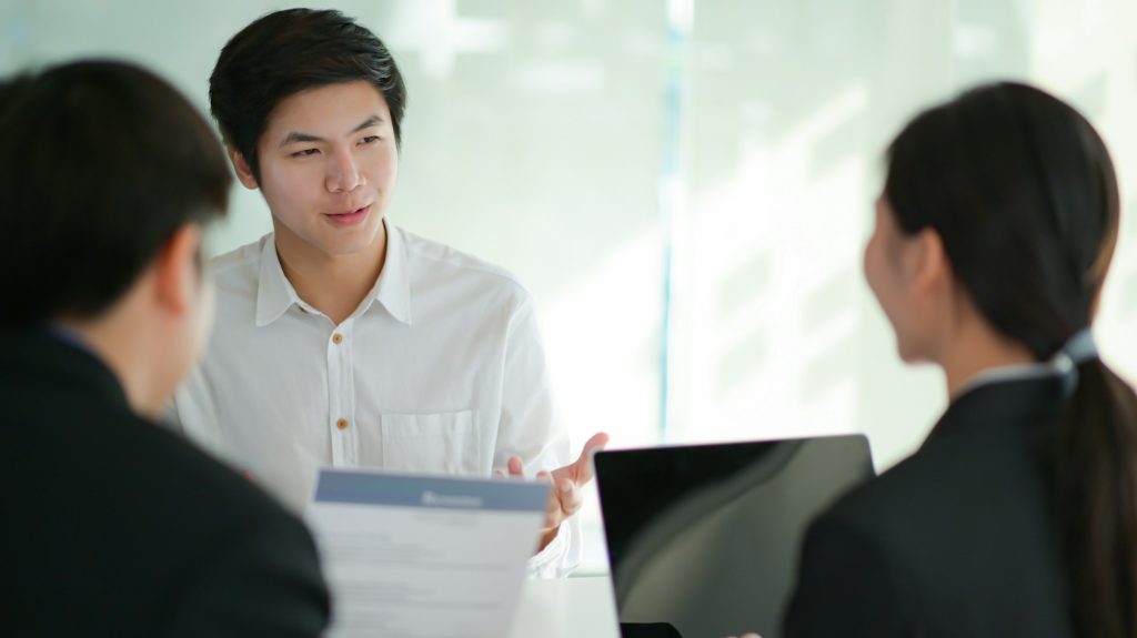 Interviewing job seekers presenting their resume for executives to consider.